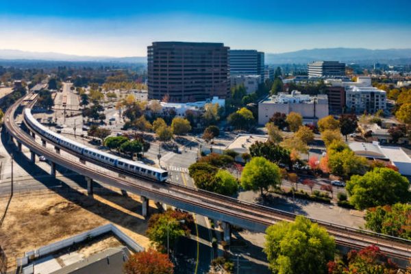 Downtown Concord skyline during autumn, with a BART Train and tracks in the foreground, and Diablo Range mountains in the background.  Concord, California is part of the San Francisco Bay Area and a suburb of San Francisco.